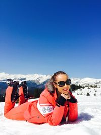 Woman standing on snow covered landscape