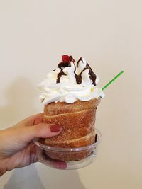 Close-up of hand holding ice cream