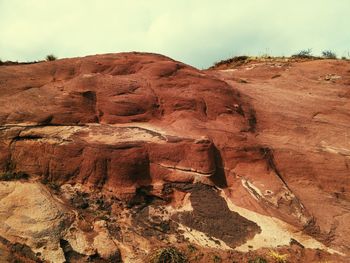 Low angle view of rock formation against sky