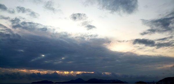 Low angle view of silhouette mountain against dramatic sky