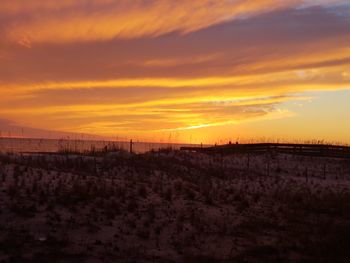 Scenic view of silhouette landscape against romantic sky at sunset