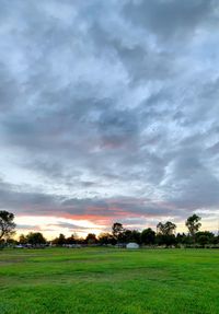 Scenic view of field against sky during sunset