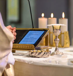 Close-up of man using laptop on table