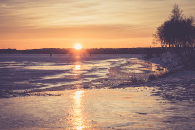 Scenic view of beach against sky during sunset