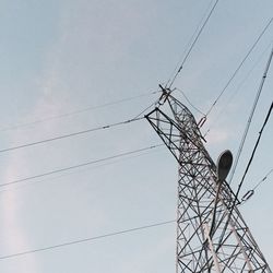 Low angle view of electricity pylon against sky