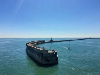 Scenic view of sea against clear blue sky