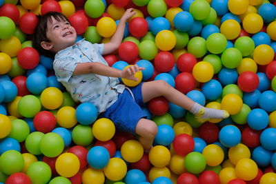 High angle view of smiling boy in ball pool