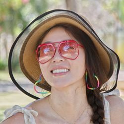 Fashinable pretty lady hacolorful glasses earrings accessories smiling happy trip leisure relaxation