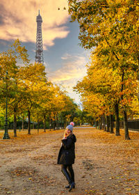 Full length of woman walking in park during autumn