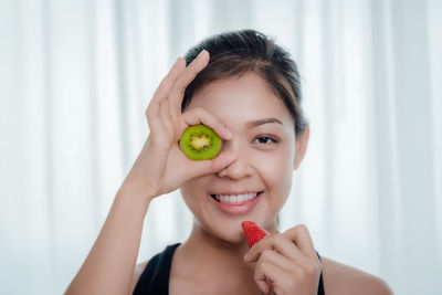 Portrait of young woman holding apple