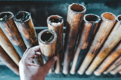 Close-up of man holding bamboo stick 