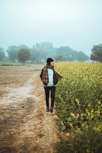 Full length of woman standing on field