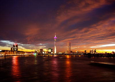 View of illuminated street light against cloudy sky