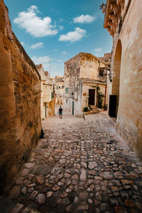 Man walking down an alleyway in the sassi of matera