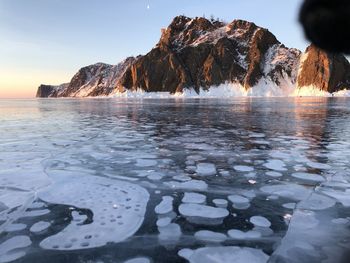 Scenic view of frozen sea against sky during winter