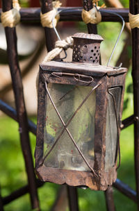 Close-up of rusty chain hanging on metal fence