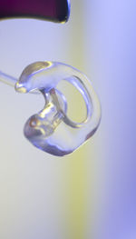 Close-up of drop falling on glass