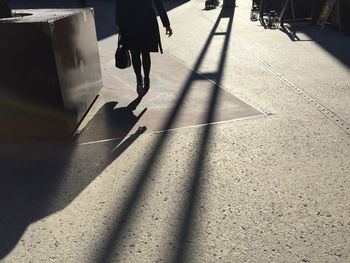 Low section of woman walking on a square