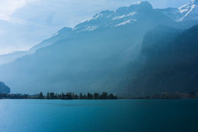 Scenic view of lake and mountains against sky