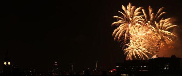 Low angle view of firework display at night