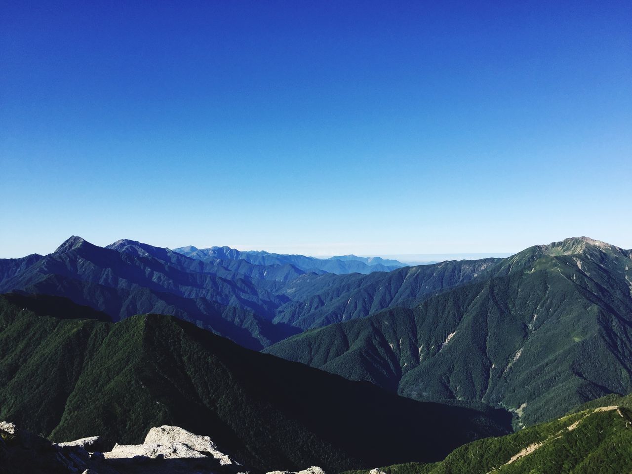 mountain, clear sky, mountain range, copy space, blue, tranquil scene, tranquility, scenics, beauty in nature, landscape, nature, non-urban scene, idyllic, remote, physical geography, day, outdoors, sunlight, geology, majestic