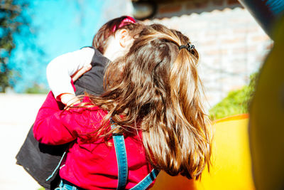 Close-up of girl holding baby outdoors
