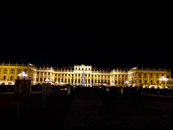 Statue in city at night