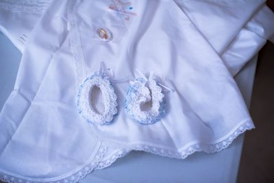 High angle view of baby clothing on bed