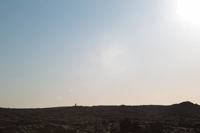 Scenic view of silhouette landscape against clear sky during sunset