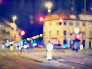 Defocused image of illuminated street at night