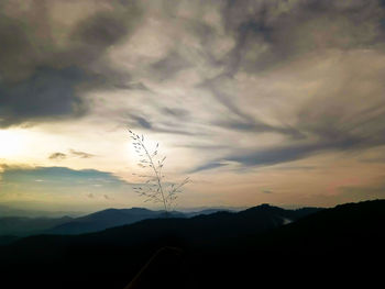 Scenic view of silhouette mountains against sky at sunset