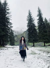 Full length of woman on snow covered land