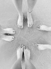 Low section of people standing on beach