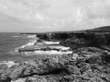 Rocks on shore against sky