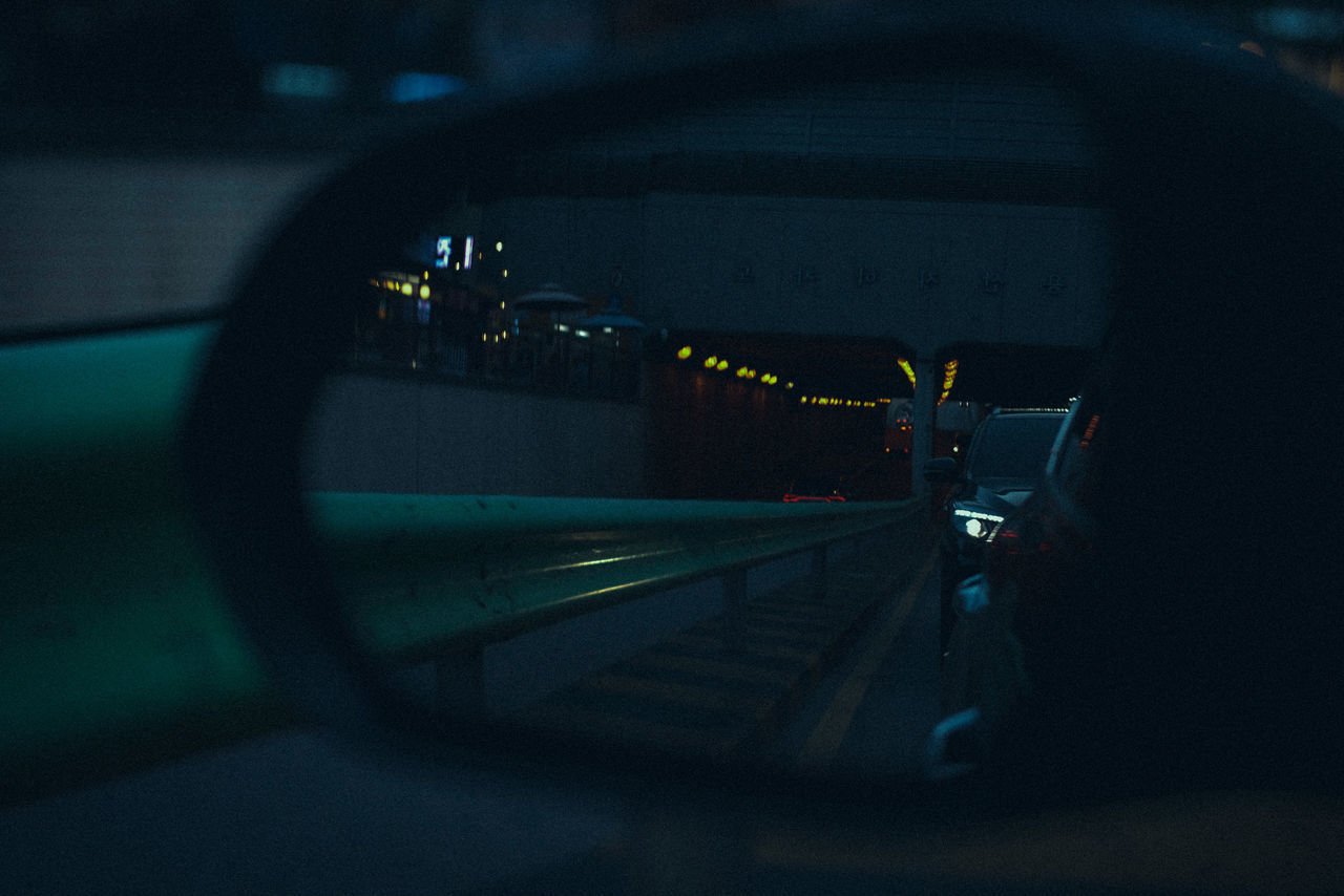 TRAIN ON RAILROAD STATION PLATFORM SEEN THROUGH WINDSHIELD