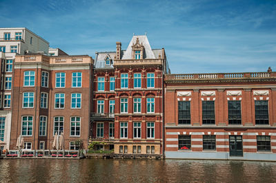 Brick buildings facade on the canal in amsterdam. the netherland capital full of canals.