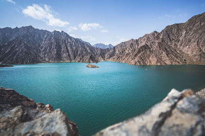 Scenic view of lake and mountains against sky