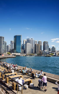 Panoramic view of sea and buildings against blue sky