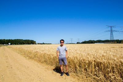 Full length portrait of man on field against sky