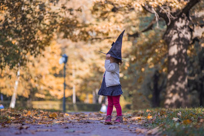 Full length of girl standing in forest