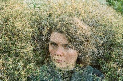 Double exposure of woman and grassy land