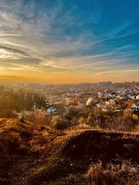 High angle view of city against sky at sunset