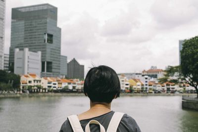 Rear view of a man overlooking cityscape