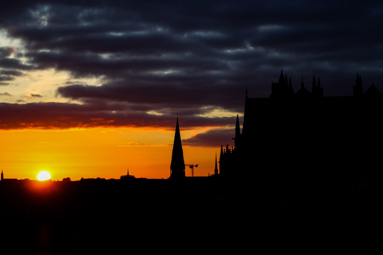 SILHOUETTE OF BUILDING AGAINST DRAMATIC SKY