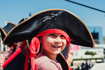 Close up portrait of 6 year multi racial boy in black pirate hat