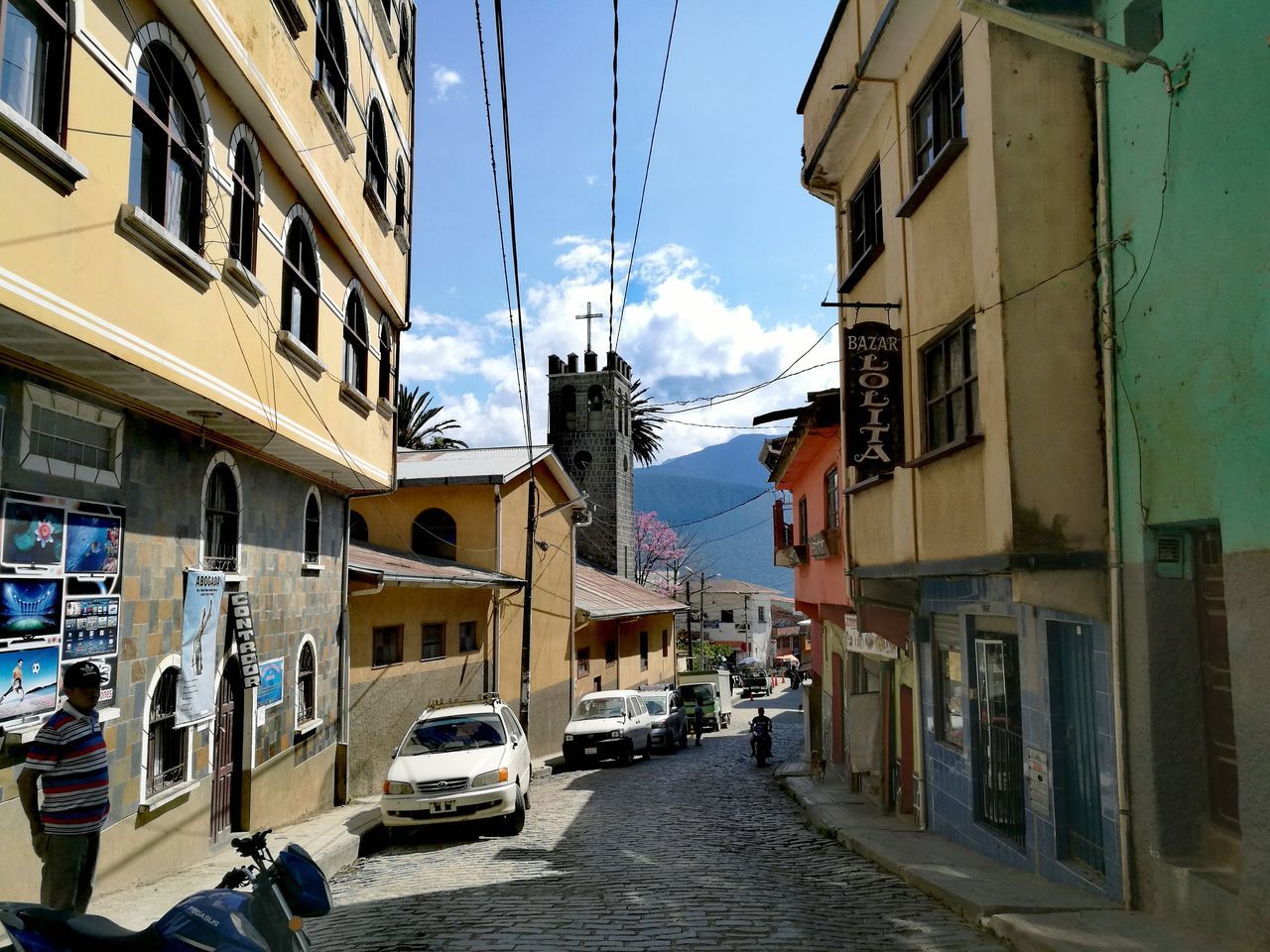 building exterior, car, architecture, built structure, street, cable, transportation, land vehicle, sky, outdoors, mode of transport, residential building, day, city, no people