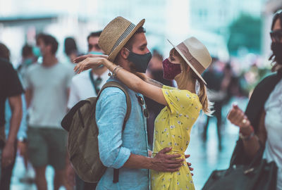 Midsection of man holding woman standing outdoors