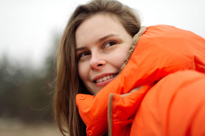 Portrait of young woman smiling outdoors