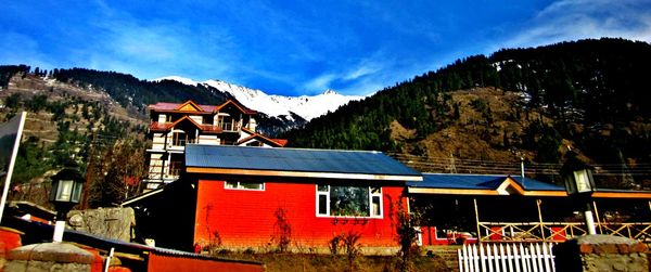 Houses against mountain range