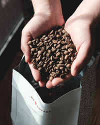 High angle view of hand holding coffee cup